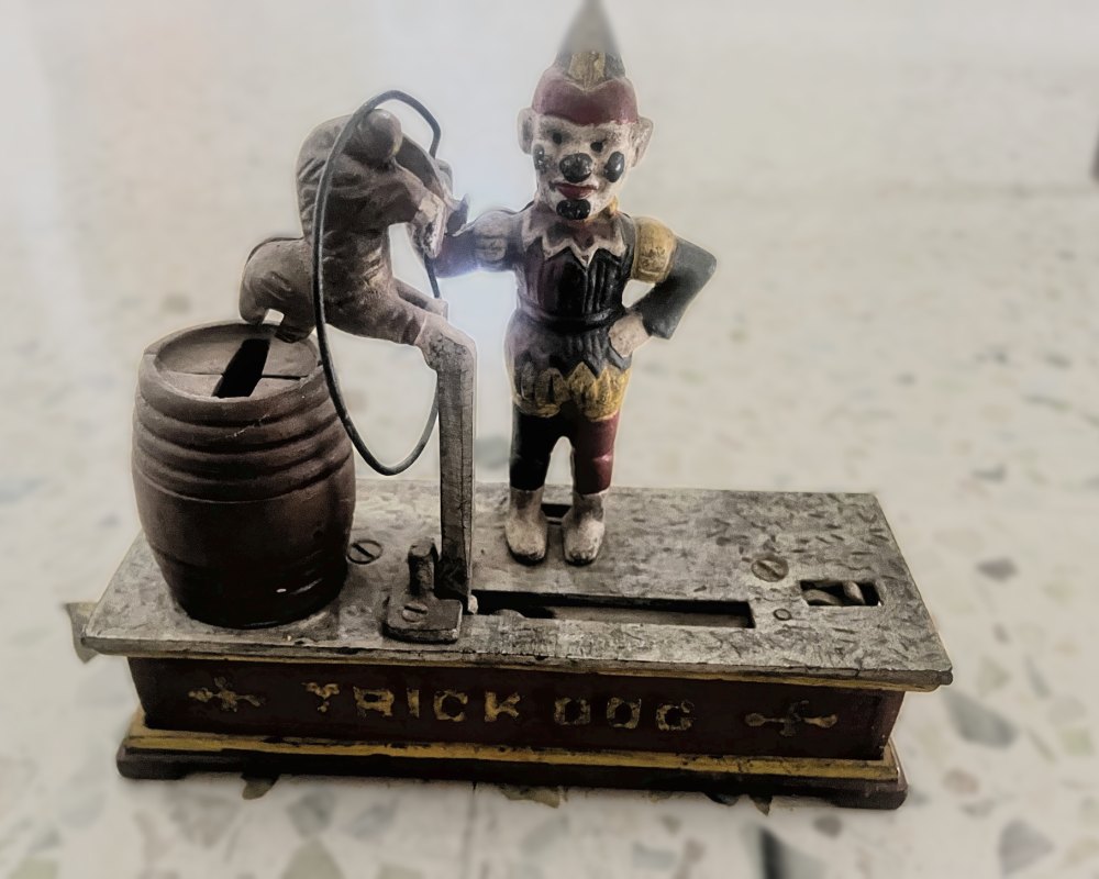 Cast-iron Trick Dog mechanical bank with a clown, a dog leaping through a hoop and a barrel
