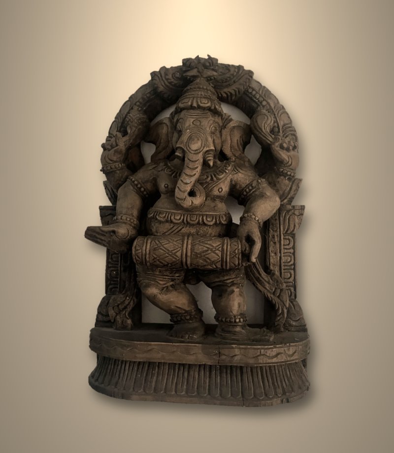 Antique teak carving of Ganesha playing the mridangam drum