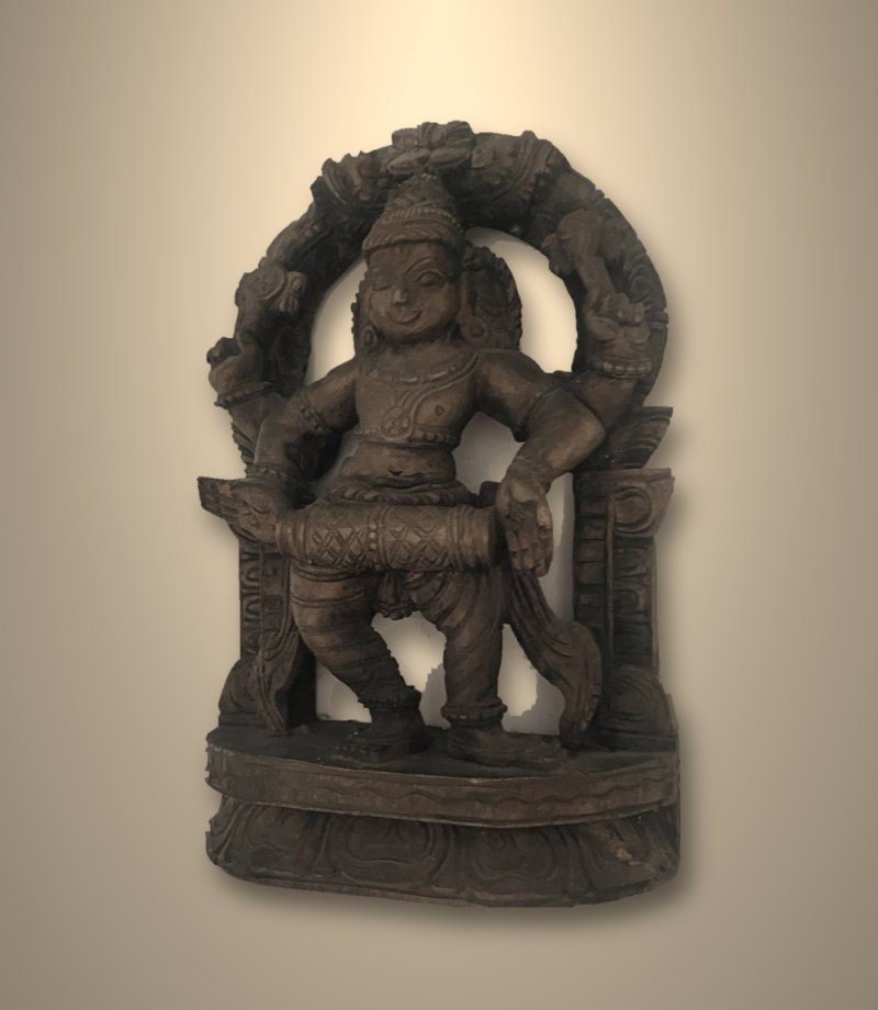 Antique teak carving of Nandikeshvara playing the mridangam drum