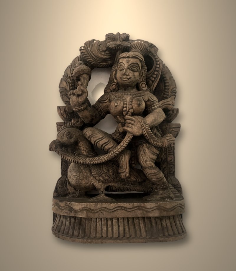 Antique teak carving of the goddess Rati riding a parrot
