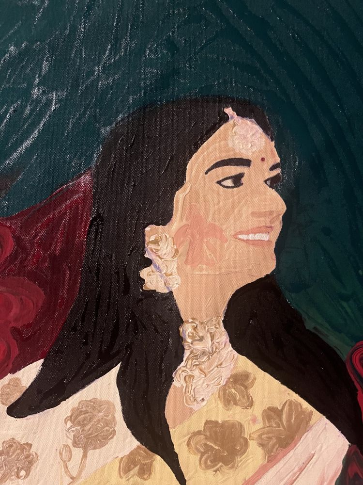 Portrait of a smiling woman in pearl jewellery and a cream and gold sari